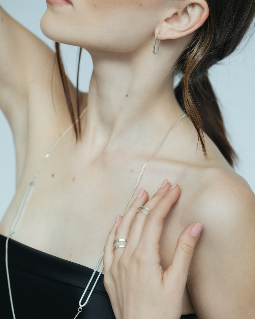 Minimalist open ring designed to create the illusion of stacking rings.