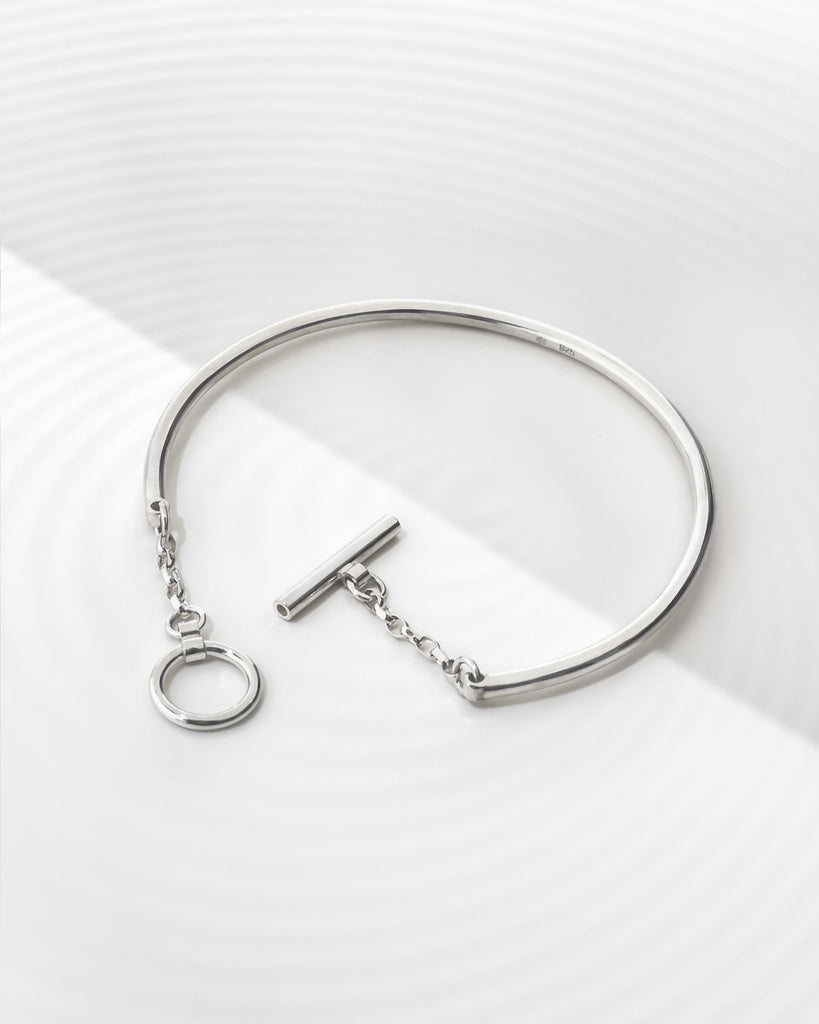 Minimalist bracelet with custom toggle clasp.