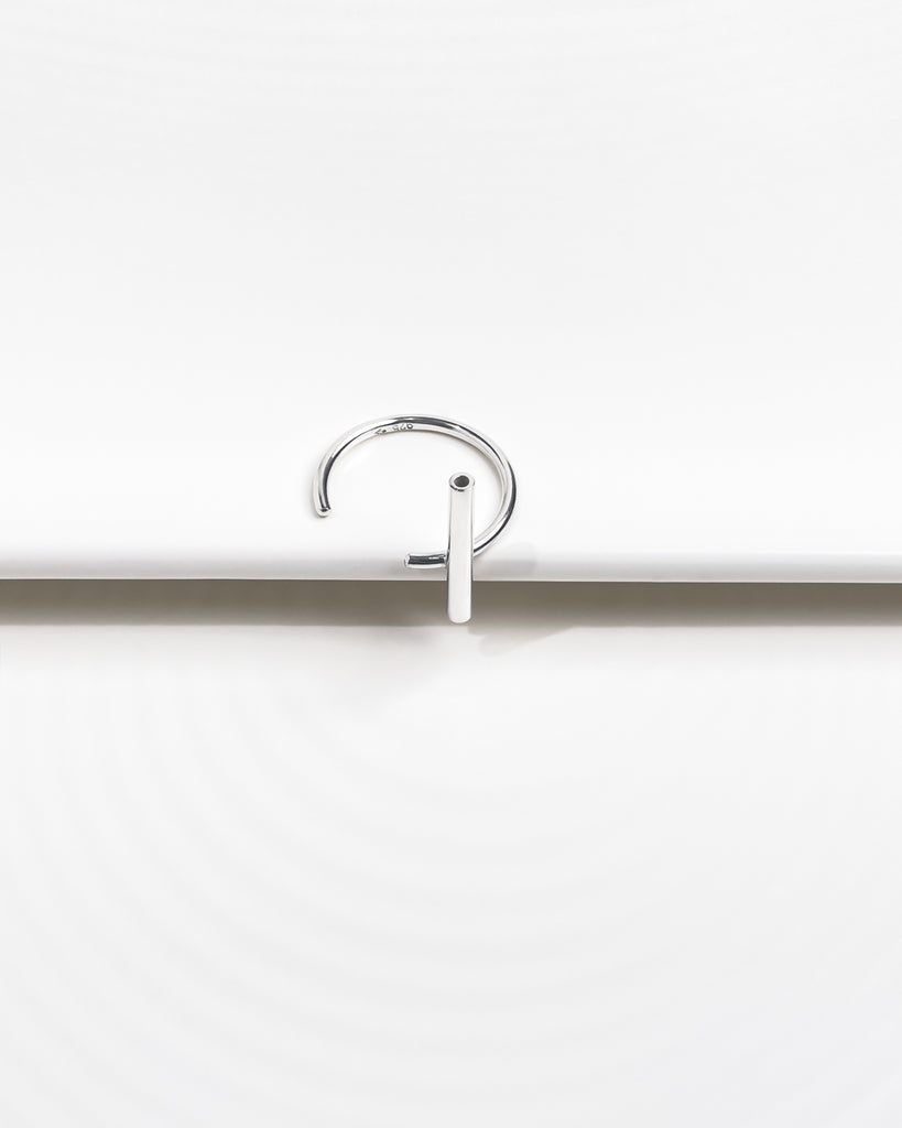 Minimalist open ring with accent tube element.